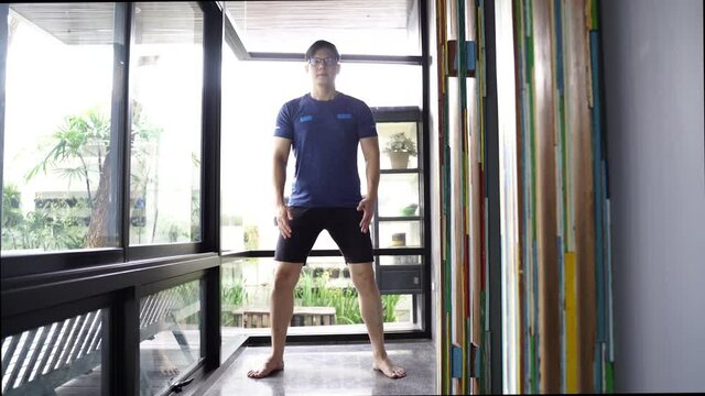 Handsome muscular mature asian man workout at home. fitness, sport and health concept.