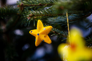 Christmas decoration on a branch of a live fir tree in the midst of the holiday