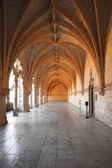 Fototapeta na wymiar Archway of an old monastery. Cloisters of Jeronimos Monastery. Lisbon Portugal