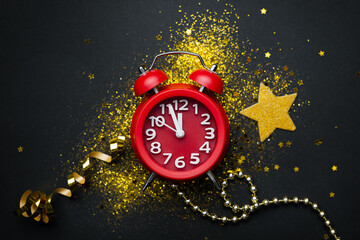 New year's composition with a red clock on a black background