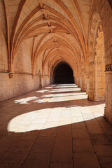 Naklejka premium Archway of an old monastery. Cloisters of Jeronimos Monastery. Lisbon Portugal
