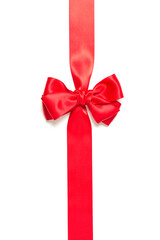 Red gift bow and vertically crossed red ribbon isolated on white background.