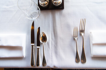 Dinner setting. Silver fork and knife on table. Restaurant interior