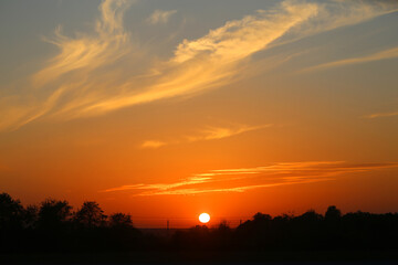 Photo of a beautiful sunset landscape over a field