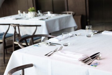 Dinner setting. Silver fork and knife on table. Restaurant interior