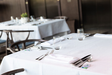 Dinner setting. Silver fork and knife on table. Restaurant interior