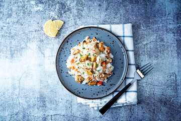 Mussel rice with pepper and parsley in a plate
