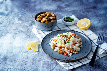Mussel rice with pepper and parsley in a plate