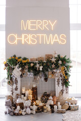 Fireplace in the living room decorated with garlands of craft gifts for the new year. Eco brown hygge decoration neutral brown tones. Christmas mood background screensaver. Festive warm stylish decor