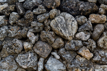 The texture of an ancient Chinese stone wall made of stones, corals and seashells.