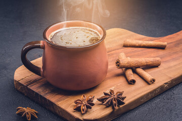 Cup of coffee , coffee beans, chocolate  and cinnamon on black background