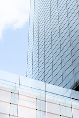Obraz premium windows with reflection of clouds and blue sky in industrial and colorful business buildings