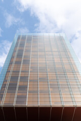 Obraz premium windows with reflection of clouds and blue sky in industrial and colorful business buildings