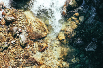Rapid creek, river water flow with rocks. Drone flight above the forest.
