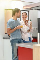 young couple have a quick breakfast in the kitchen