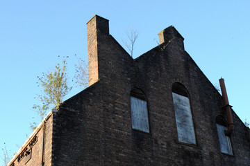 Fototapeta na wymiar Gable of Derelict Industrial Brick Building seen from Below