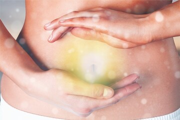 Beautiful woman's slim stomach, and hands showing a balance in her microflora