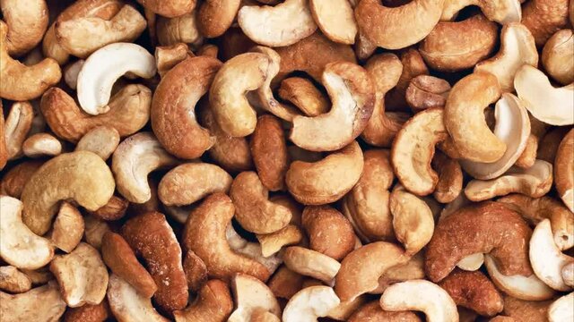 Rotating cashew nuts peeled full. View from above.