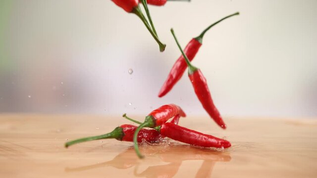 Chili Peppers Falling onto the Wet Wooden Table and Splashing Water Drops in 1000fps (Phantom Flex)