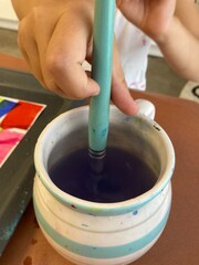 hand holding a paint brush