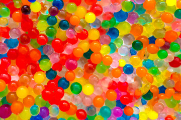 The texture is a lot of different color balls. Set of multi-colored orbeez. Many multicolored orbits