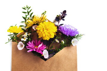 Summer  flowers in a brown paper envelope on the white background. Birthday, Women's day  concept, mother's day. Flat lay. Aster, daisy, bindweed