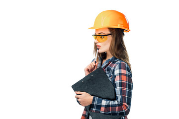Attractive young woman in building helmet with folder and orange protective glasses over the white background. Female builder in shirt.