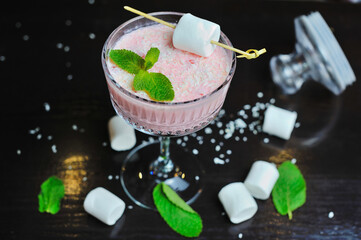 The cocktail is beautiful, delicious with lime, mint and ice in a glass