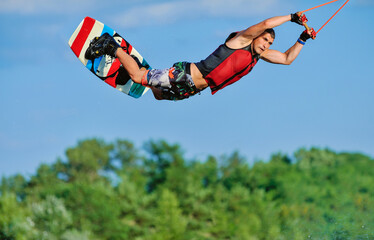Wakeboarder surfing across a lake