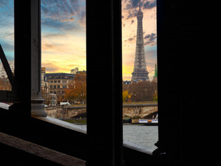 Paris, France - November 29, 2019 - Under a bridge the view of the Eiffel Tower