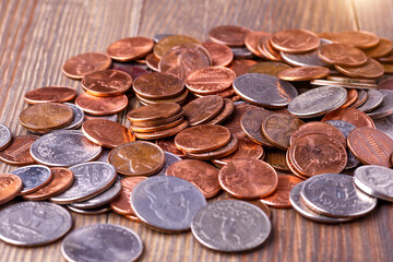 American coins and US dollars on a wooden table