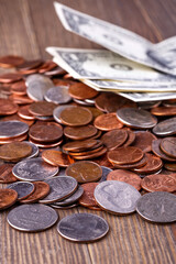American coins and US dollars on a wooden table
