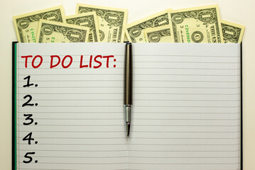 White note with inscription 'TO DO LIST' on beautiful white background, metalic pen, dollar bills....