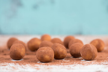 Marzipan potatoes, in german called Marzipankartoffeln, with cacao powder, sweets for christmas, empty copy space