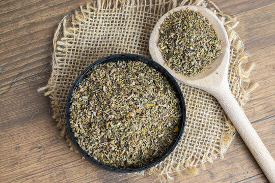Dry, finely ground cistus leaves, herbal tea on wooden spoon