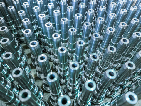 Shiny long steel parts full frame background, clean steel rods after fine cnc turning.