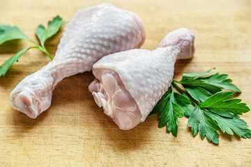 fresh raw chicken legs on a cutting board