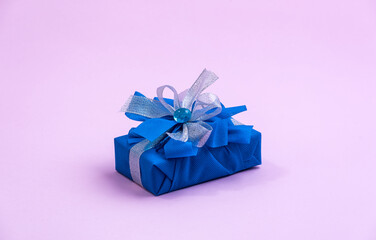 Classic blue surprise gift box with blue and white ribbon, background with copy space