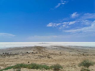 Landscape of a deserted salt lake. The texture of salt formations in the foreground. salt lake surface, dry salt lake, white salt lake