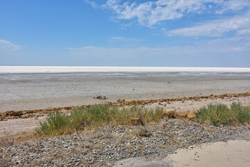 Landscape of a deserted salt lake. The texture of salt formations in the foreground. salt lake surface, dry salt lake, white salt lake