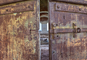 rusty metal door in an abandoned church, entrance to an abandoned temple