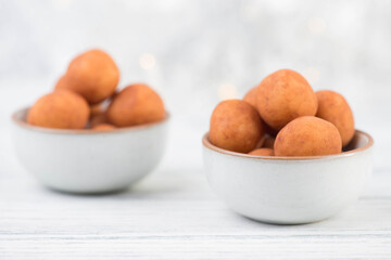 Marzipan potatoes, in german called Marzipankartoffeln, with cacao powder, sweets for christmas, empty copy space