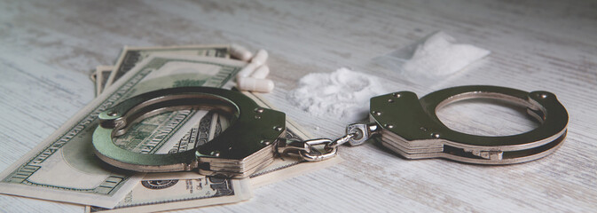 Drugs and handcuffs composition. Selective focus. Crime concept. Illegal money.