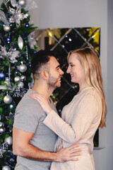 Fototapeta premium family couple hugging over Christmas tree