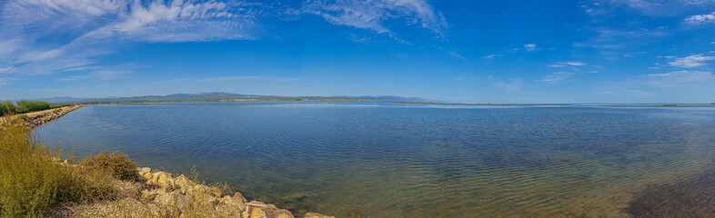 Panorama of the Ebro delta landscape with water and blue sky