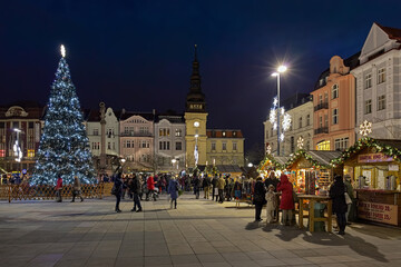 Christmas market on Masaryk square in Ostrava, Czech Republic. At the opposite end of the square is located the Old Town Hall (now the City Museum) and the Marian Column.