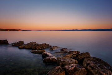 Fototapeta na wymiar Croatia, Brac island, beach Supetrus at sunrise near Supetar. August 2020. Long exposure picture.