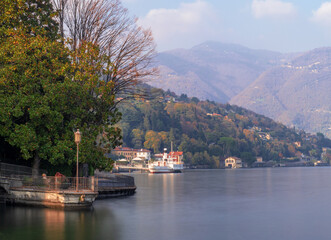 Fototapeta na wymiar autumn landscape from the scenic lakeside promenade of Como.Como Lake, Lombardy, Italian Lakes, Italy