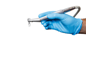 A dentist doctor holds a dental instrument on a white isolated background. The hand with the tool close up