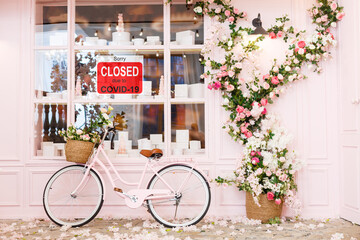 Business center closed due to COVID-19, sign with sorry in door window. Stores, restaurants,...
